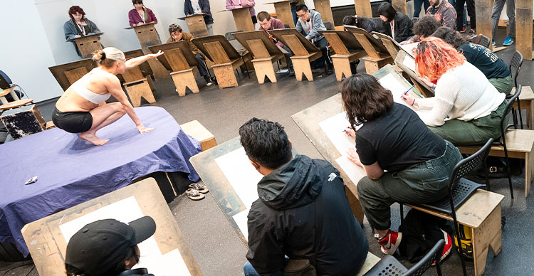 VFS animation students participating in a Life Drawing class, sketching a human model.