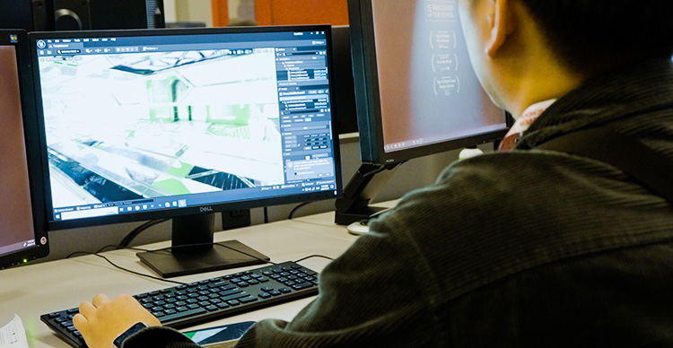 VFS student working on developing a video game project for their portfolio on campus.