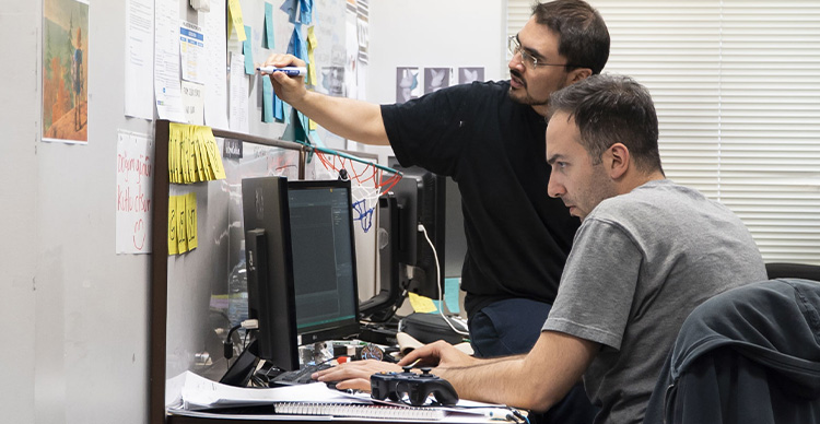Vancouver Film School students collaborating on building a video game project.
