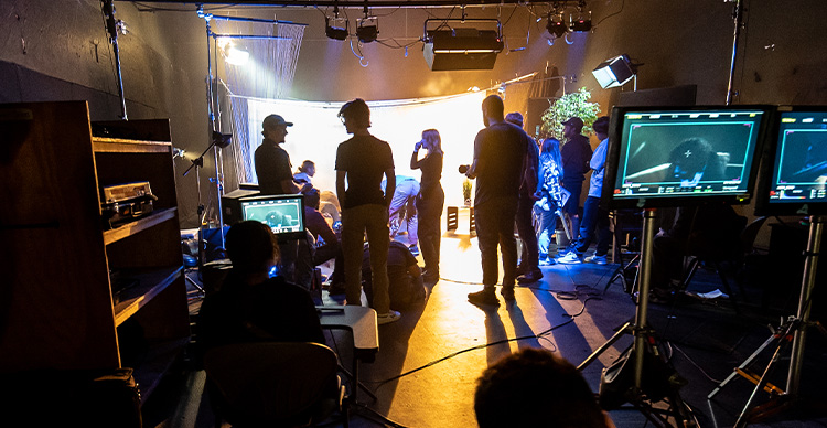 Vancouver Film School students collaborating on the set of a film production.