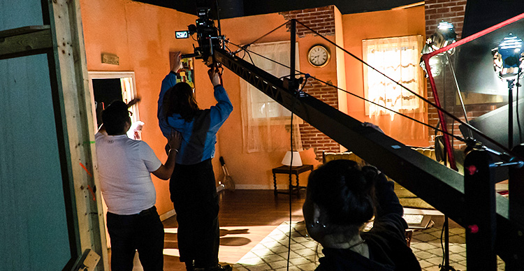Film Production students at VFS attaching a camera to a jib for a film shoot.