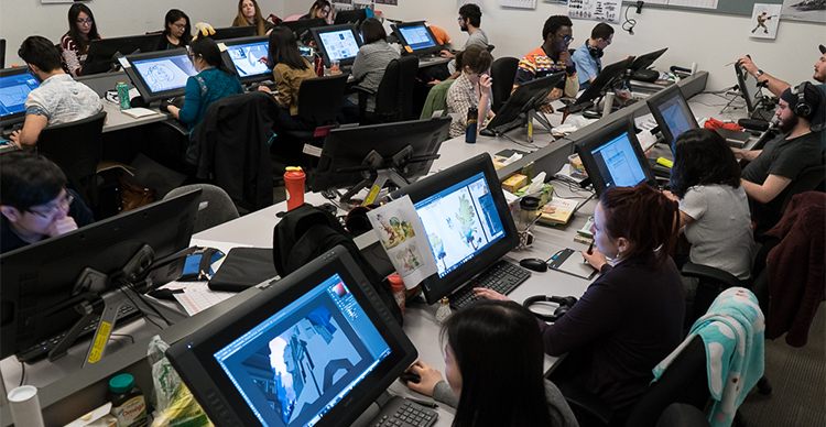 Animation students working at computers in a Vancouver Film School lab environment during hands-on production training.