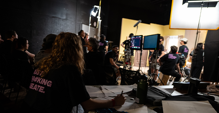 Behind-the-scenes photo from a previous Vancouver Film School In-Production Bootcamp, showing participants collaborating on a live film production set. 