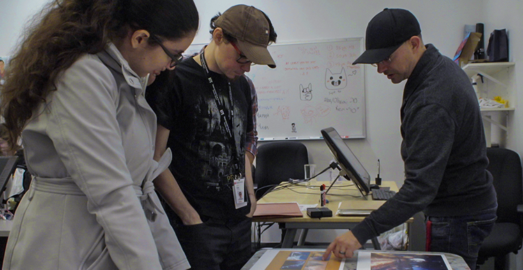 Colin Giles reviews animation work with Vancouver Film School students during a classroom critique.