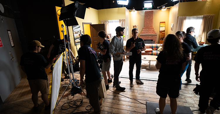 Students collaborate on a busy VFS film set during an acting bootcamp led by Emmy Award-winning director Michael Spiller, gaining hands-on production experience.